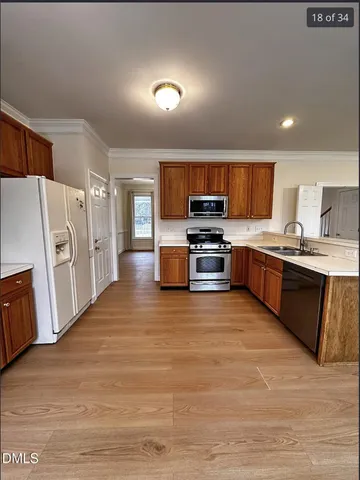a large kitchen with stainless steel appliances and a refrigerator