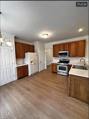 a kitchen with stainless steel appliances a refrigerator and a stove top oven