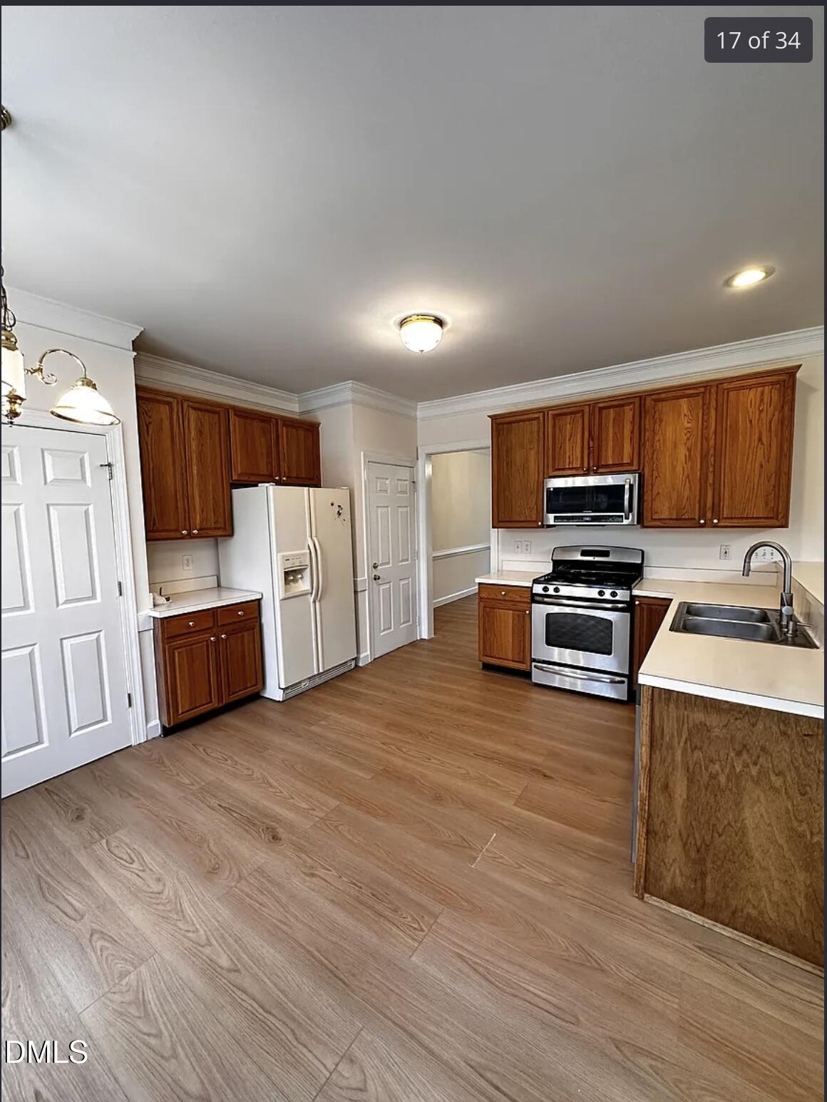 214 Cobble Ridge Drive Chapel Hill, NC 27516 - Photo 10 of 34 a kitchen with stainless steel appliances a refrigerator and a stove top oven