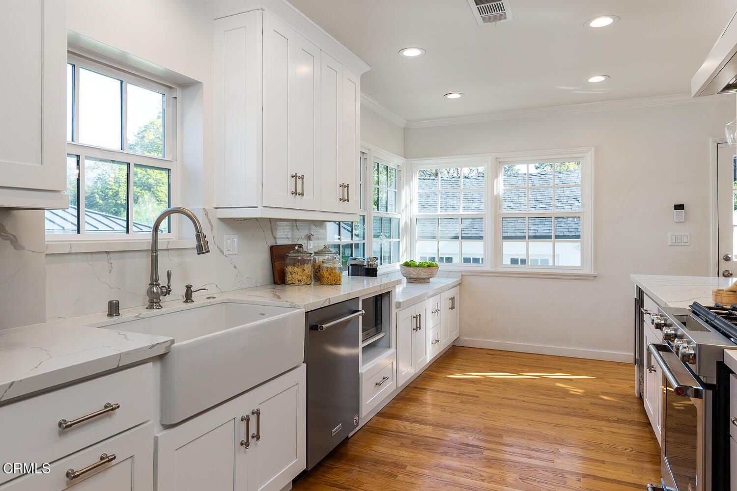 1200 Charles Street Pasadena, CA 91103 - Photo 9 of 27 a kitchen with granite countertop a sink and white cabinets with wooden floors