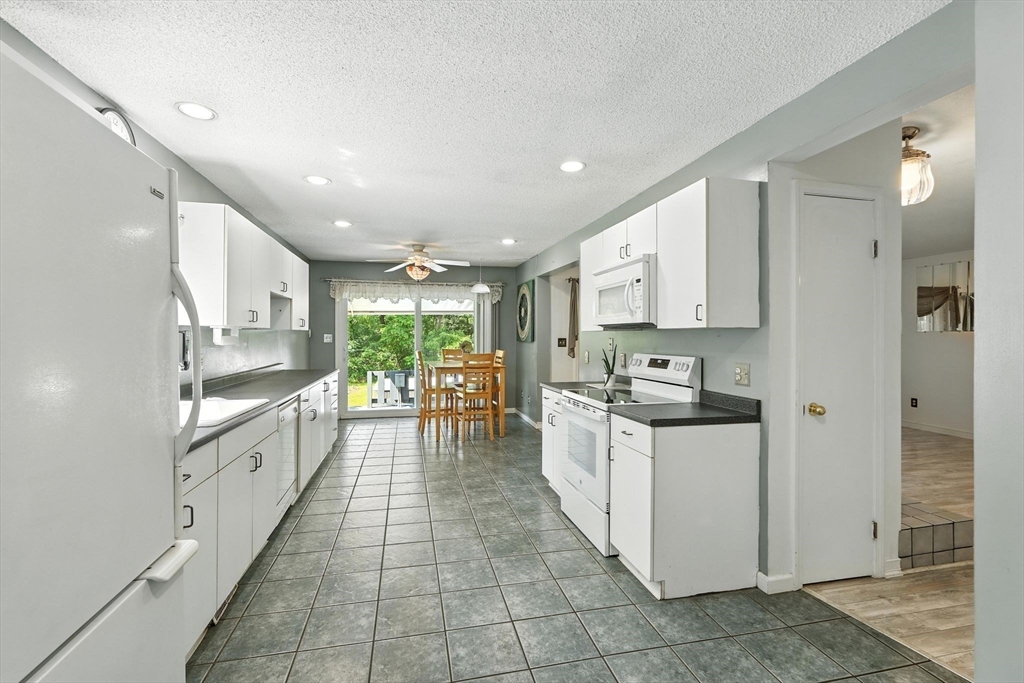 12 Pond Brook Road Huntington, MA 01050 - Photo 17 of 38 a large kitchen with stainless steel appliances lots of white cabinets