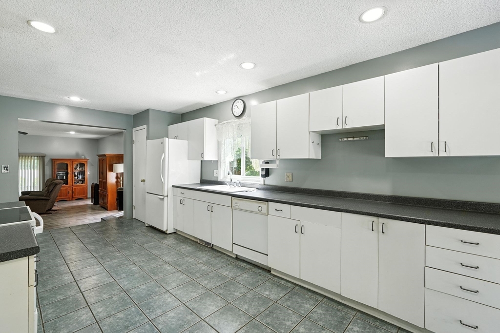 12 Pond Brook Road Huntington, MA 01050 - Photo 18 of 38 a large white kitchen with cabinets