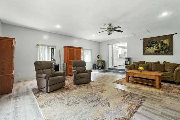 a living room with furniture a ceiling fan and a rug