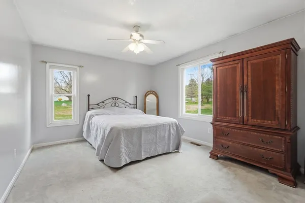 a spacious bedroom with a bed and a window