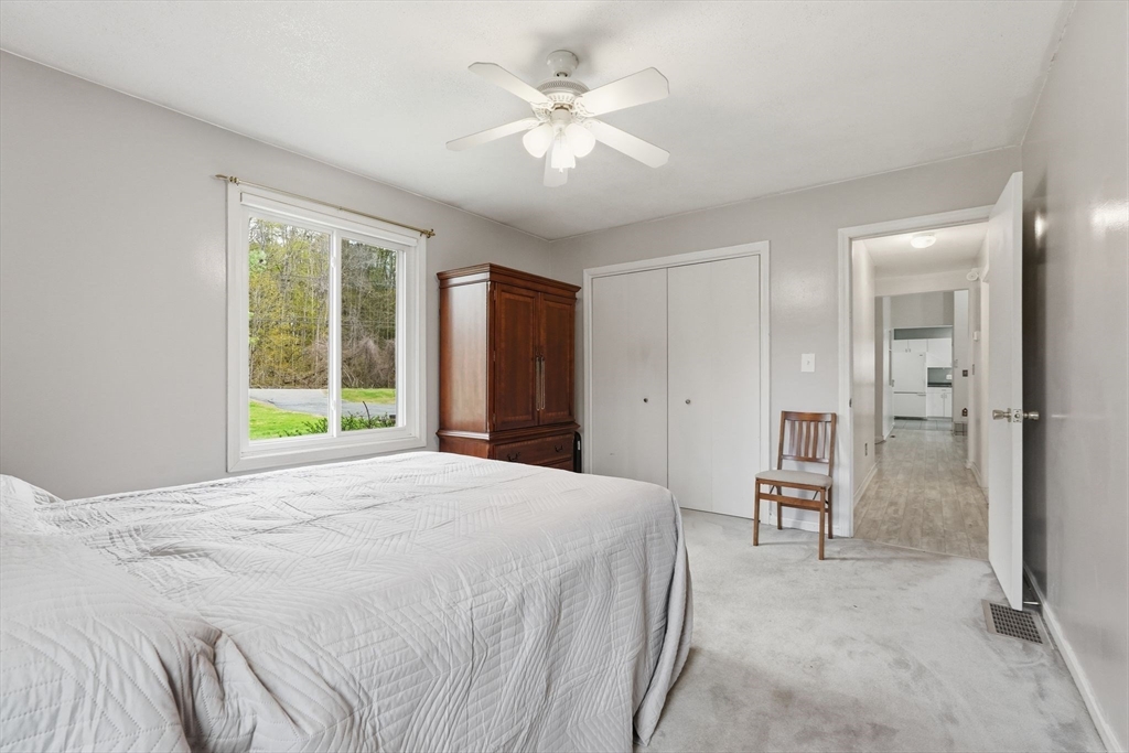12 Pond Brook Road Huntington, MA 01050 - Photo 24 of 38 a spacious bedroom with a bed and a chandelier
