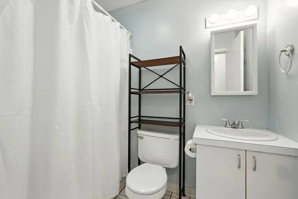 a bathroom with a sink a toilet and mirror