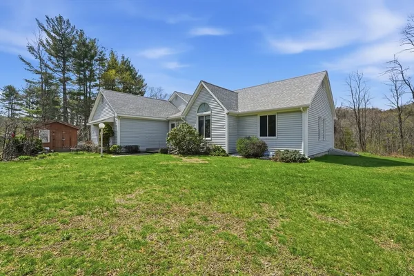 a front view of house with yard and green space