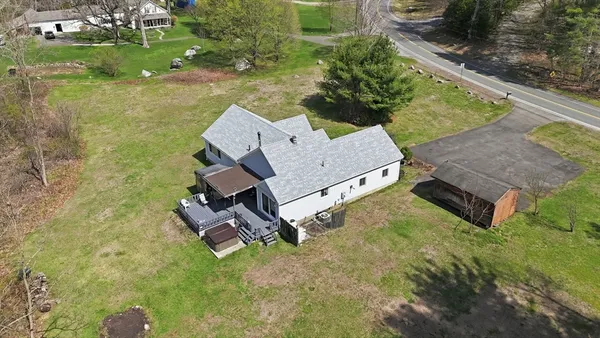 an aerial view of a house with a yard