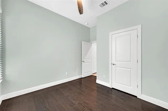 an empty room with wooden floor