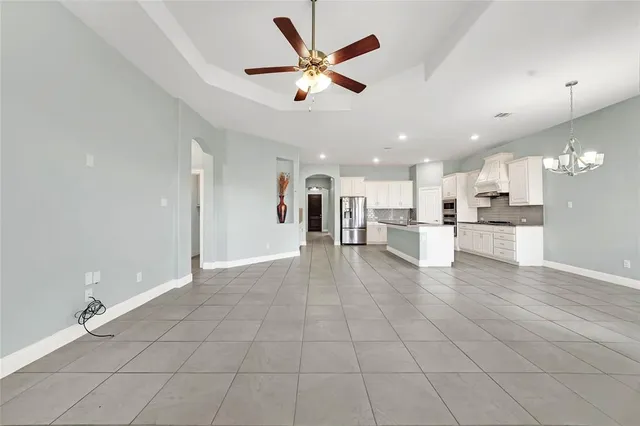 a view of kitchen with a sink and refrigerator