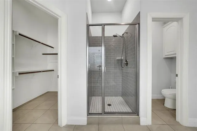 a bathroom with a shower and a toilet