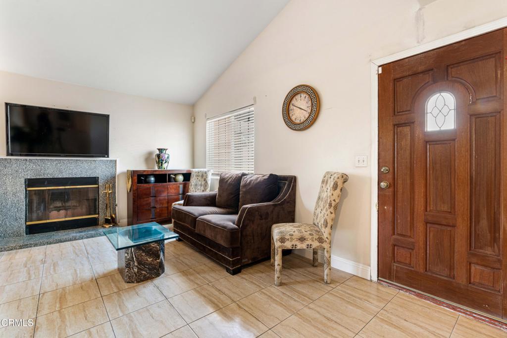 907 West Mission Road, Unit B Alhambra, CA 91801 - Photo 2 of 27 a living room with furniture a flat screen tv and a fireplace