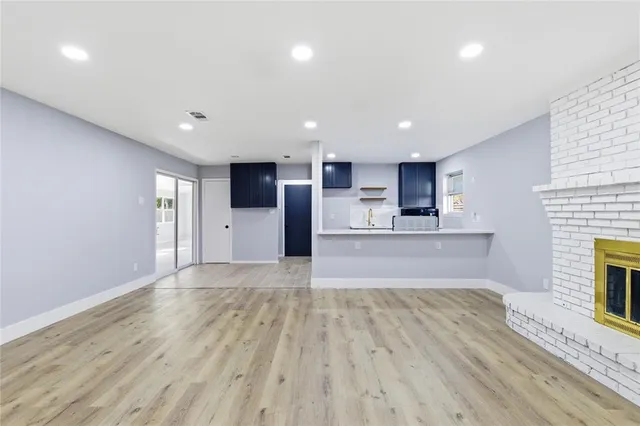a view of a kitchen with a sink and a refrigerator