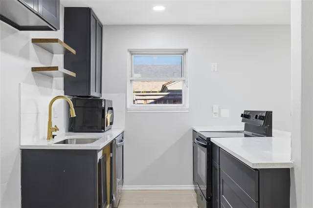 a kitchen with a sink cabinets and a window