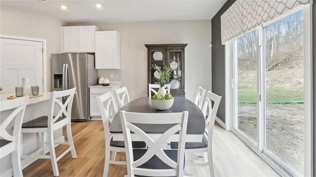 a dining room with furniture a chandelier and wooden floor