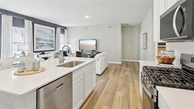 a kitchen with a sink stove and cabinets
