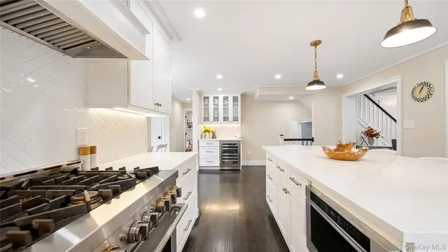 a kitchen with stove and wooden floor