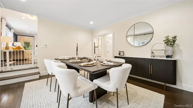 a view of a dining room with a table and chairs