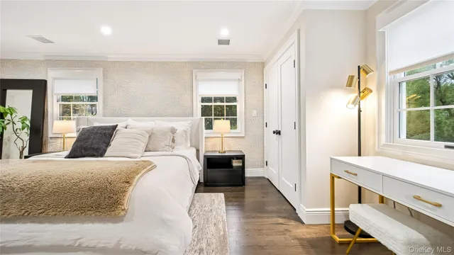 a bedroom with a large bed and a window