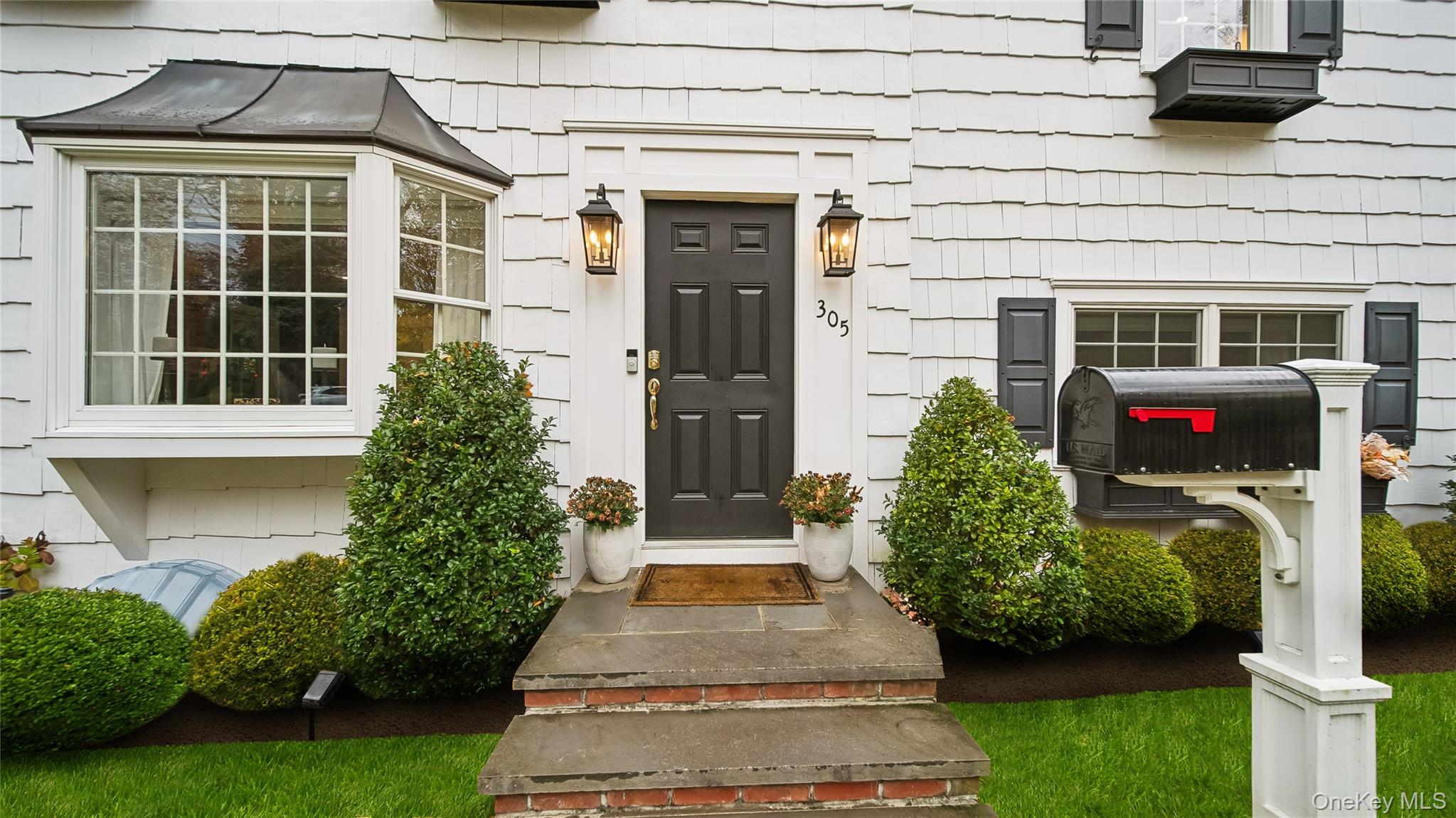 305 Nassau Avenue Manhasset, NY 11030 - Photo 2 of 27 a front view of a house with garden