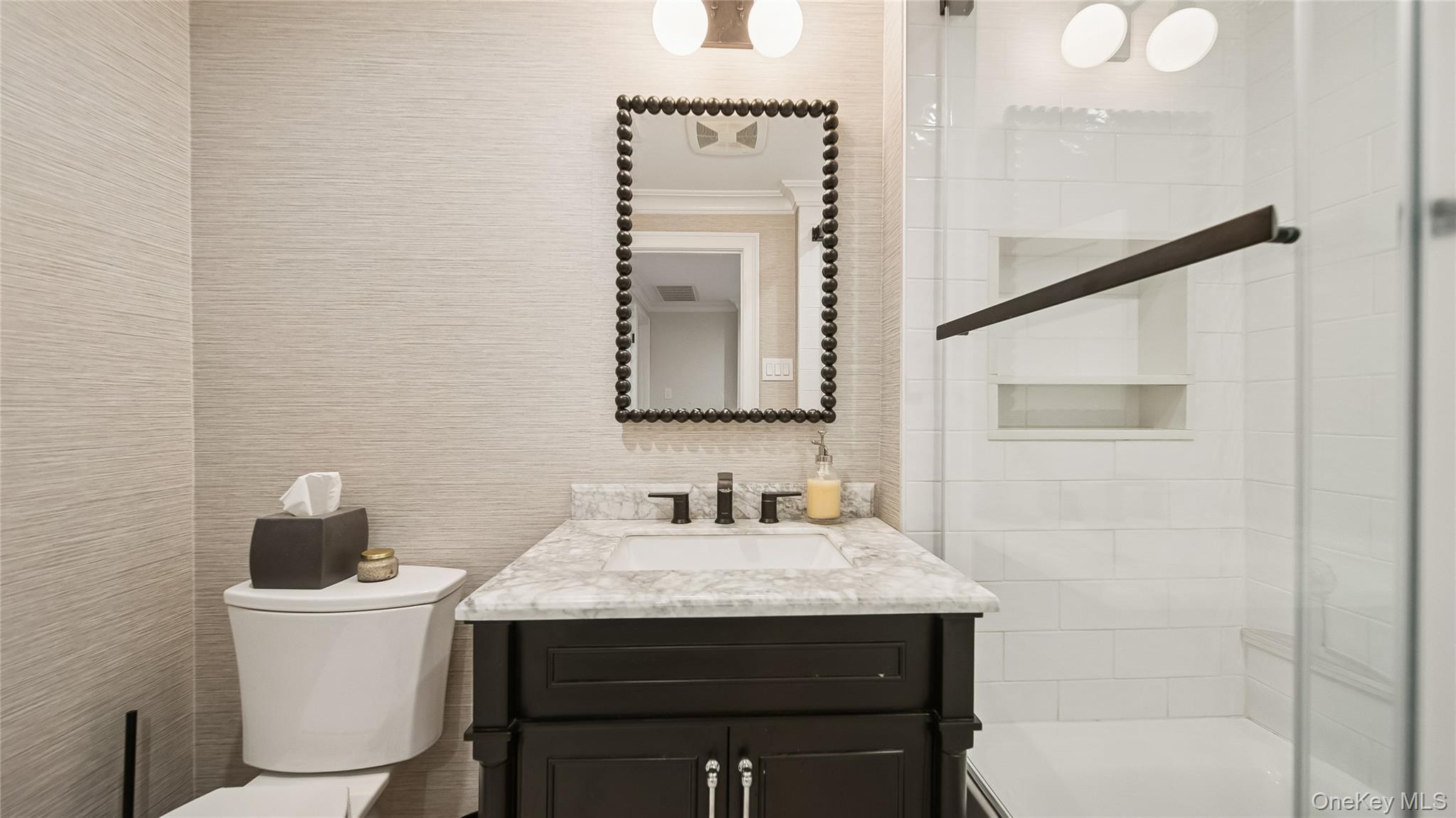 305 Nassau Avenue Manhasset, NY 11030 - Photo 22 of 27 a bathroom with a sink and a mirror