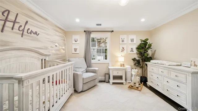 a balcony with couple of white furniture and potted plants