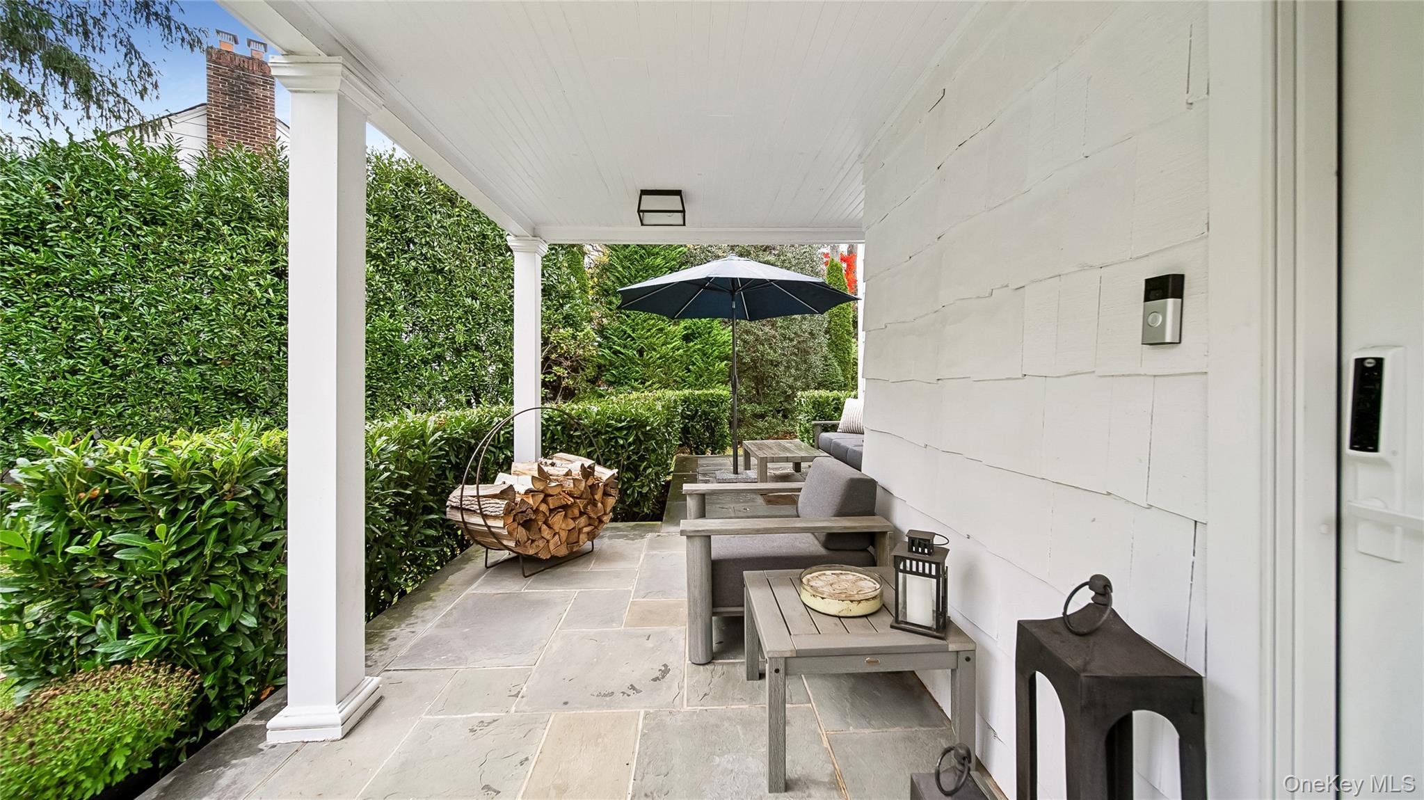 305 Nassau Avenue Manhasset, NY 11030 - Photo 24 of 27 a balcony with couple of white furniture and potted plants