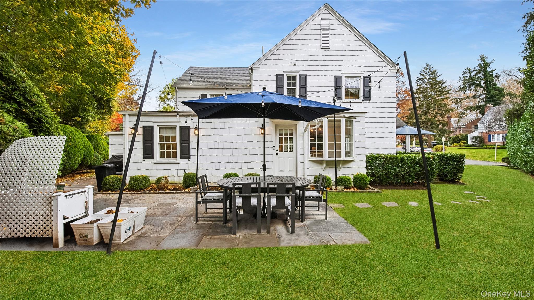 305 Nassau Avenue Manhasset, NY 11030 - Photo 26 of 27 a view of a house with a backyard and chairs