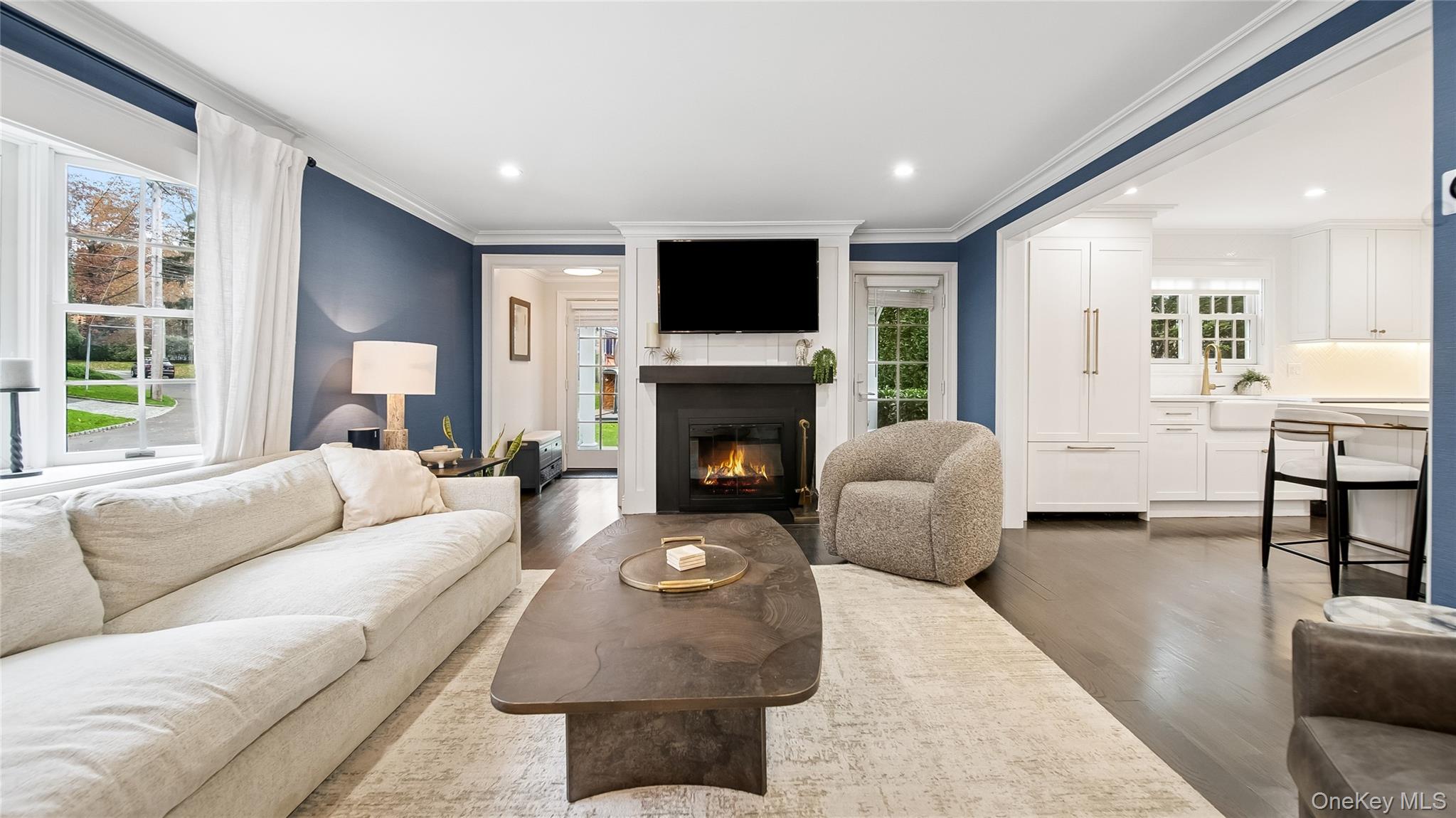 305 Nassau Avenue Manhasset, NY 11030 - Photo 3 of 27 a living room with furniture a flat screen tv and a fireplace