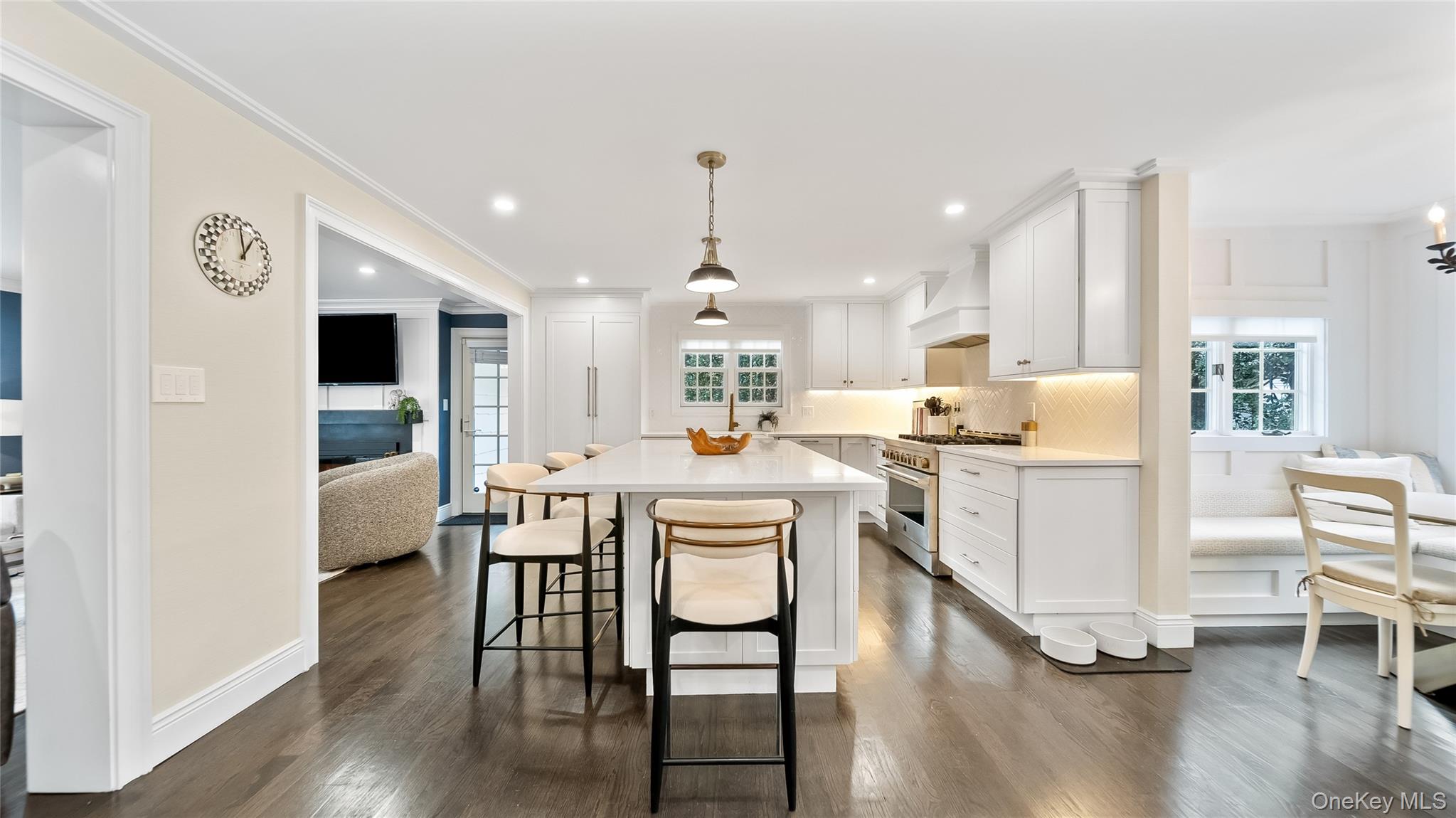305 Nassau Avenue Manhasset, NY 11030 - Photo 6 of 27 a living room with kitchen island furniture a dining table wooden floor and a large window
