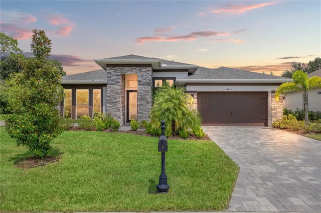 a front view of a house with a yard and garage