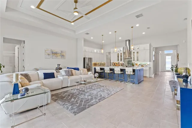 a kitchen with stainless steel appliances granite countertop a large kitchen island a stove a sink and a refrigerator