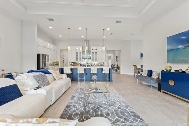 a view of a dining room with furniture a chandelier and window