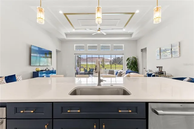 a view of a dining room with furniture a chandelier and wooden floor