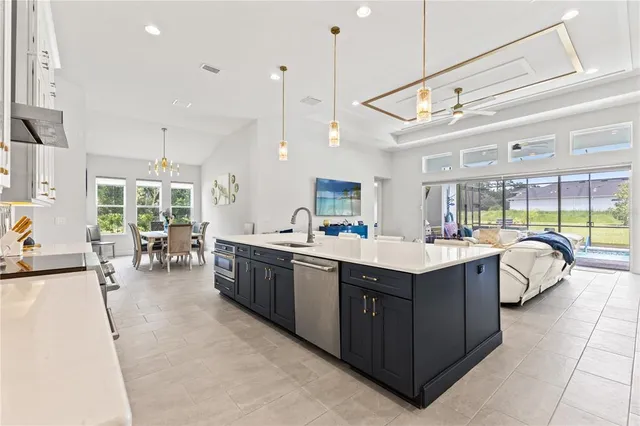 a living room with furniture and kitchen view