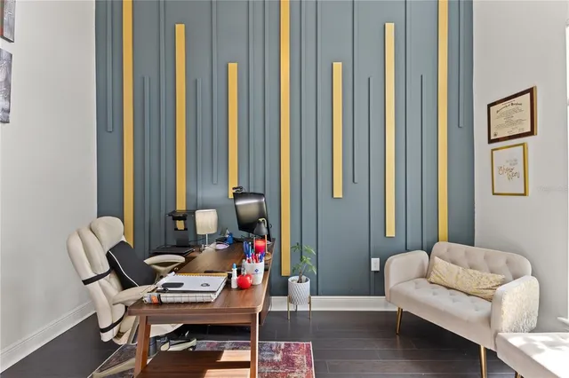 a bed sitting in a spacious bedroom next to a window