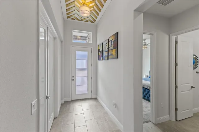 a living room with furniture a sink a flat screen tv and kitchen view
