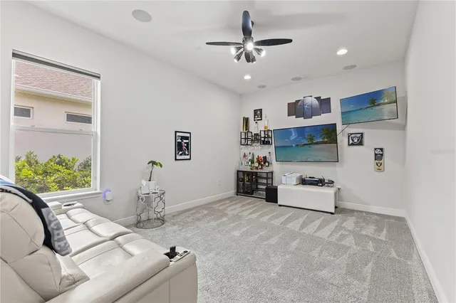 a living room with furniture and a floor to ceiling window