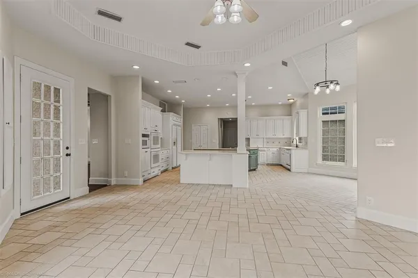 a view of a kitchen with kitchen island and stainless steel appliances