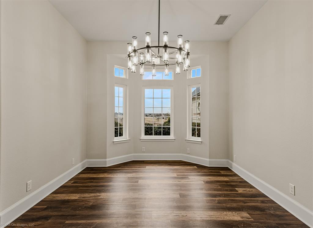 15183 Valley View Forney, TX 75126 - Photo 13 of 38 a view of an empty room with wooden floor and a window