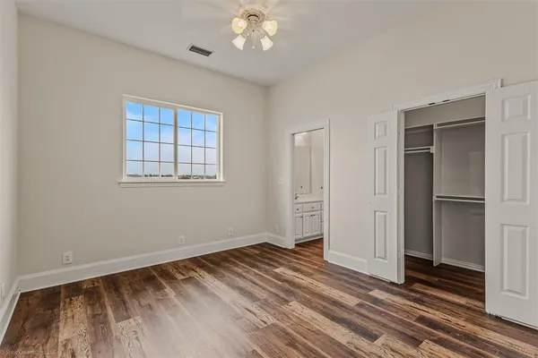 a view of a livingroom with wooden floor and a ceiling fan