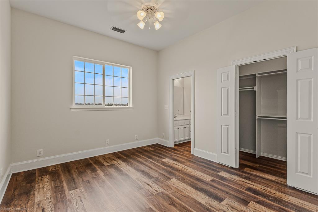 15183 Valley View Forney, TX 75126 - Photo 21 of 38 a view of a livingroom with wooden floor and a ceiling fan