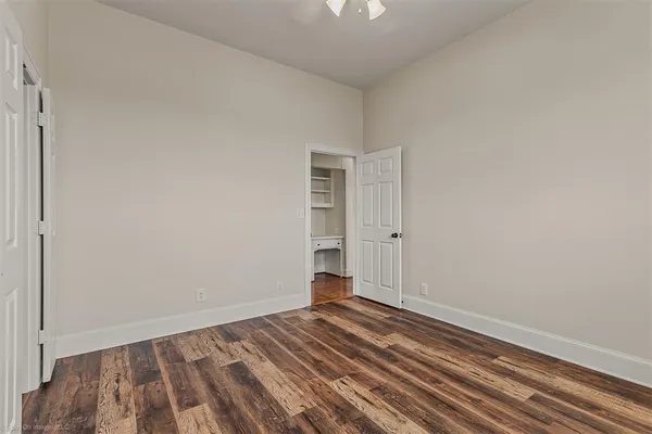 a view of a room with wooden floor and closet