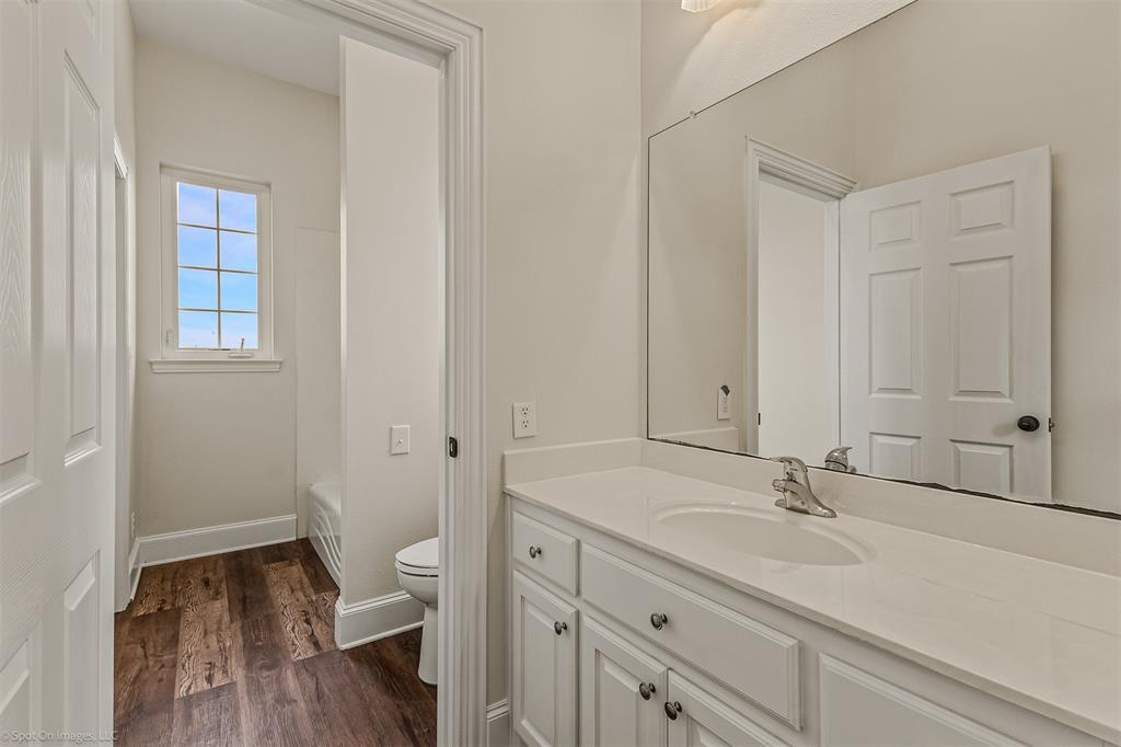 15183 Valley View Forney, TX 75126 - Photo 26 of 38 a bathroom with a sink a toilet and a window