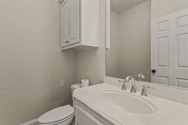 a bathroom with a sink a toilet and mirror