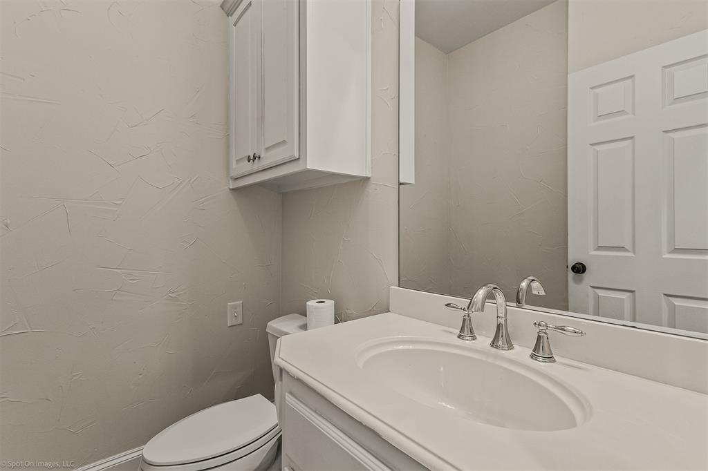 15183 Valley View Forney, TX 75126 - Photo 27 of 38 a bathroom with a sink a toilet and mirror