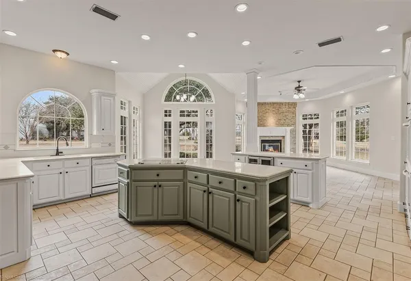 a kitchen with a stove sink and cabinets