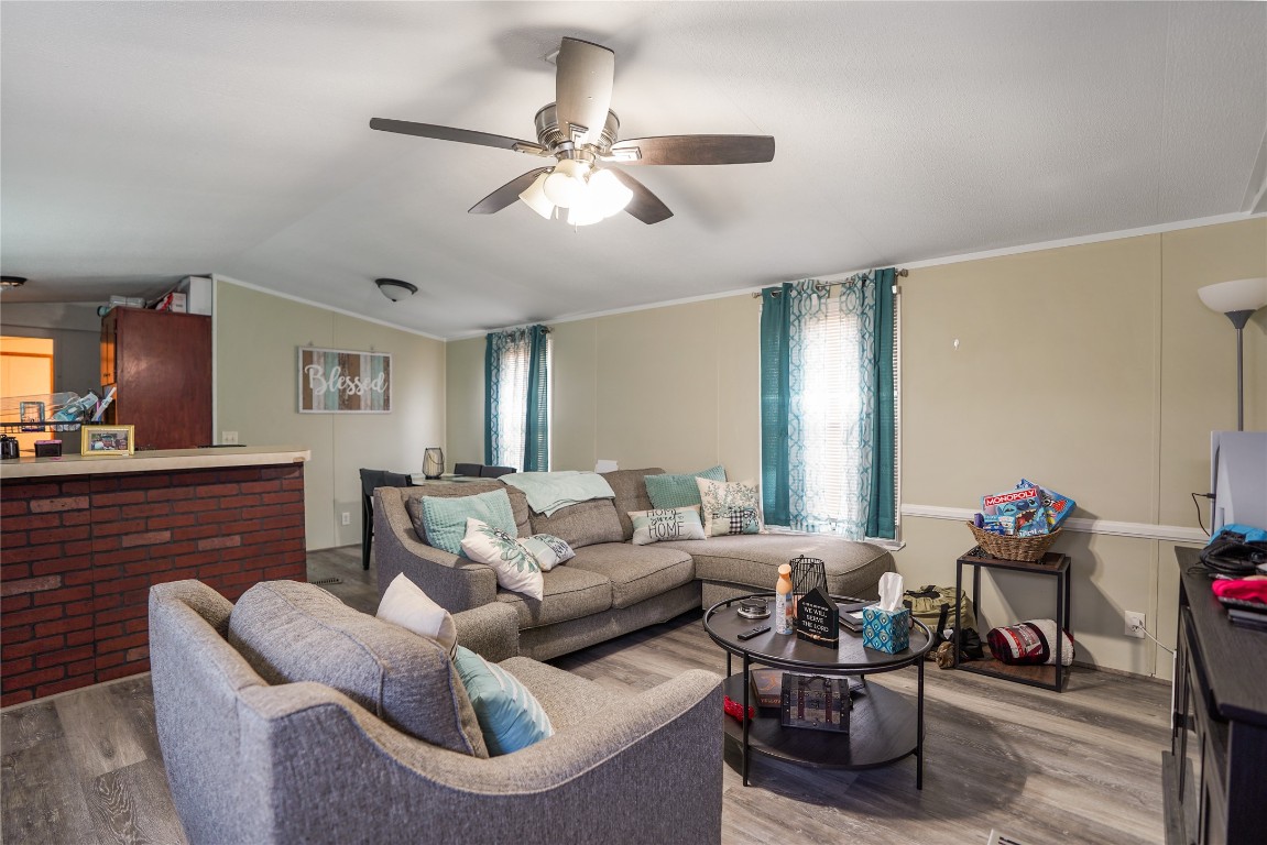 207 Riverside Street Highlands, TX 77562 - Photo 14 of 29 a living room with furniture and a wooden floor