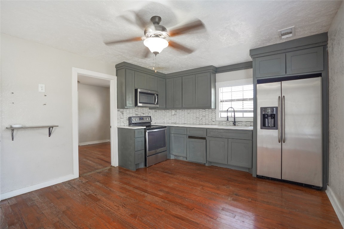 207 Riverside Street Highlands, TX 77562 - Photo 16 of 29 a kitchen with a refrigerator sink and cabinets