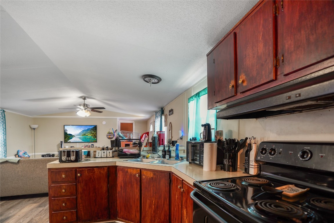 207 Riverside Street Highlands, TX 77562 - Photo 20 of 29 a kitchen with stainless steel appliances granite countertop a stove and a sink
